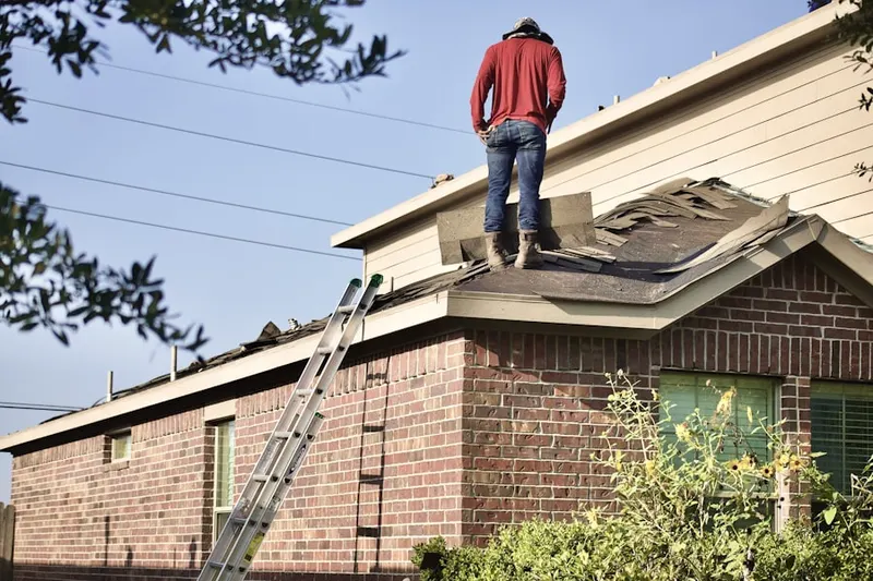 Professional roofer working on a residential roof in Malibu Hills